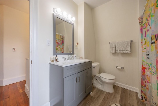 16 Malvern Ave, Cranston, RI 02905 - full bath with wood finished floors, toilet, vanity, and baseboards