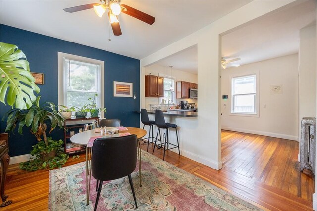 16 Malvern Ave, Cranston, RI 02905 - dining room with ceiling fan, light wood-style floors, and baseboards