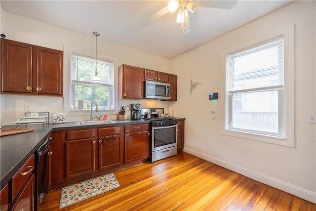 16 Malvern Ave, Cranston, RI 02905 - kitchen featuring appliances with stainless steel finishes, a sink, dark countertops, and light wood-style flooring
