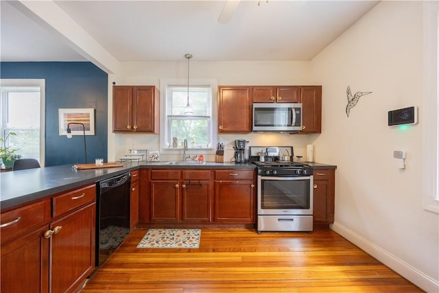 16 Malvern Ave, Cranston, RI 02905 - kitchen with appliances with stainless steel finishes, dark countertops, light wood finished floors, a sink, and baseboards