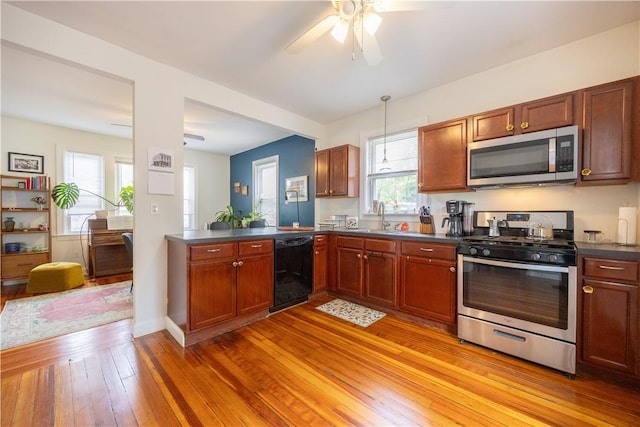 16 Malvern Ave, Cranston, RI 02905 - kitchen with stainless steel appliances, dark countertops, a sink, a ceiling fan, and light wood-style flooring