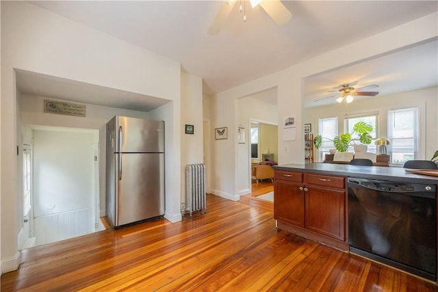 16 Malvern Ave, Cranston, RI 02905 - kitchen with freestanding refrigerator, black dishwasher, radiator heating unit, and a ceiling fan