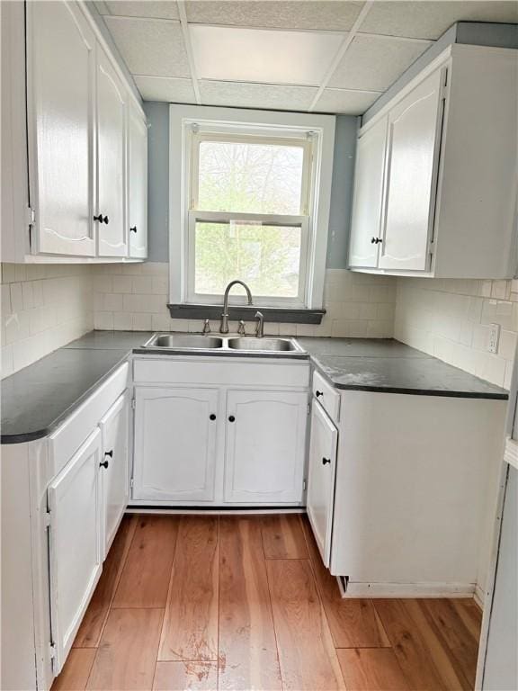 74 Pontiac St, Warwick, RI 02886 - kitchen featuring a sink, light wood finished floors, and white cabinetry