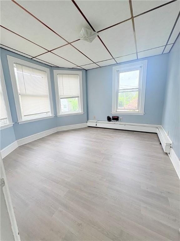 74 Pontiac St, Warwick, RI 02886 - spare room with wood finished floors, baseboards, and a baseboard heating unit