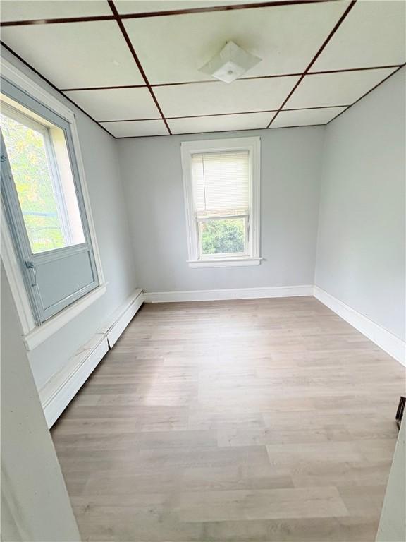 74 Pontiac St, Warwick, RI 02886 - unfurnished room with light wood-style flooring, a baseboard heating unit, and baseboards