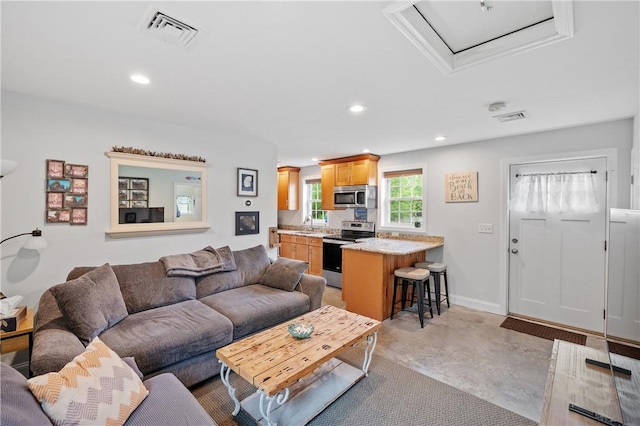 882 Point Judith Rd, Narragansett, RI 02882 - living area featuring finished concrete floors, recessed lighting, and attic access