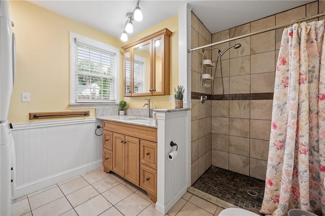 882 Point Judith Rd, Narragansett, RI 02882 - bathroom featuring vanity, tile patterned floors, tiled shower, and wainscoting