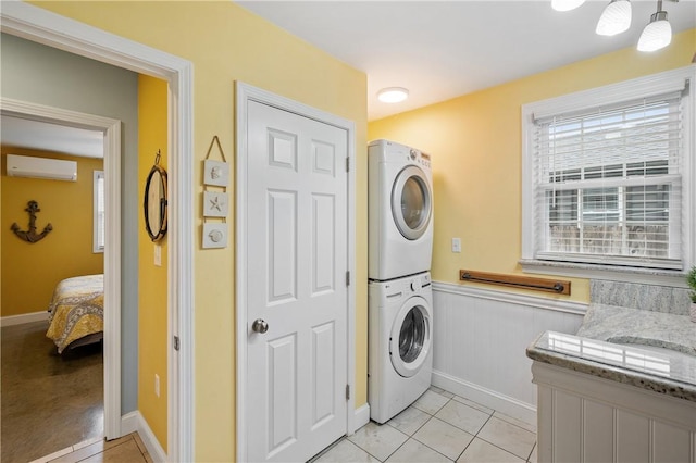 882 Point Judith Rd, Narragansett, RI 02882 - laundry area with stacked washer / dryer, a wall unit AC, wainscoting, and light tile patterned floors