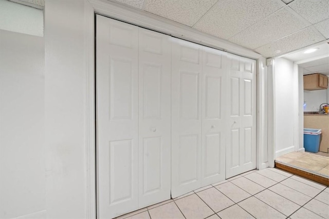 320 Beverage Hill Ave, Pawtucket, RI 02861 - unfurnished bedroom with light tile patterned floors, a closet, and a paneled ceiling