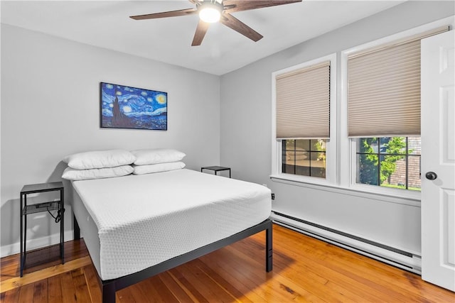 30 Brown St Unit 2, Narragansett, RI 02882 - bedroom with baseboard heating, wood-type flooring, and ceiling fan