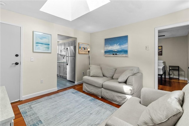 30 Brown St Unit 2, Narragansett, RI 02882 - living area with a skylight, dark wood-style flooring, and baseboards