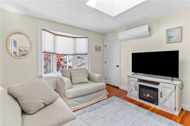 30 Brown St Unit 2, Narragansett, RI 02882 - living room with a wall unit AC, wood finished floors, a skylight, and baseboards