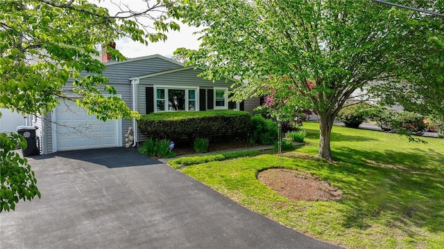 11 Laurelhurst Rd, Cranston, RI 02920 - view of front of house featuring asphalt driveway, a front yard, a garage, and a chimney