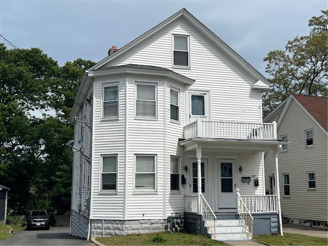 1097 Pontiac Ave, Cranston, RI 02910 - view of front of house featuring a balcony, a chimney, and a porch