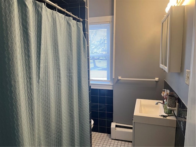 1097 Pontiac Ave, Cranston, RI 02910 - bathroom featuring toilet, a baseboard radiator, plenty of natural light, vanity, and tile walls