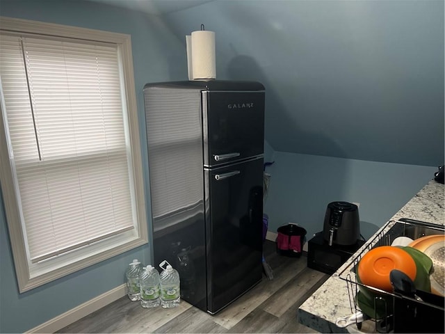 1097 Pontiac Ave, Cranston, RI 02910 - kitchen view of wood finished floors, freestanding refrigerator, and baseboards