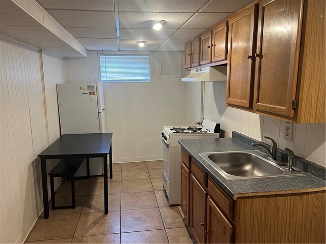 1097 Pontiac Ave, Cranston, RI 02910 - kitchen with white appliances, a sink, under cabinet range hood, dark countertops, and brown cabinetry
