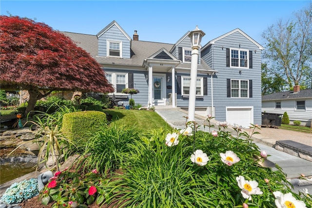 62 Andrews Ave, West Warwick, RI 02893 - back of house with a garage, driveway, a chimney, and a shingled roof