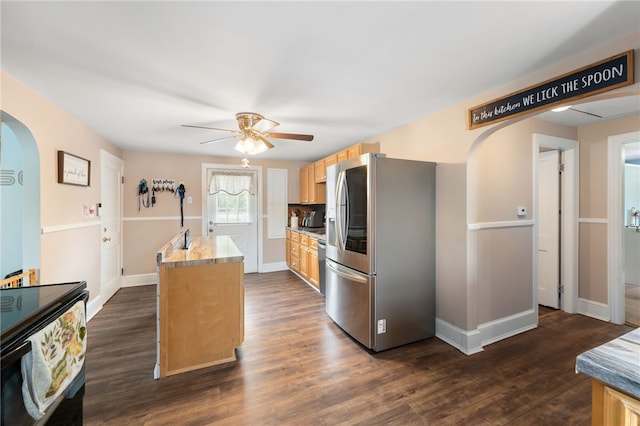 62 Andrews Ave, West Warwick, RI 02893 - kitchen featuring stainless steel fridge with ice dispenser, a ceiling fan, arched walkways, a center island, and light brown cabinetry