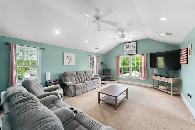 62 Andrews Ave, West Warwick, RI 02893 - living area with a wood stove, lofted ceiling, a ceiling fan, healthy amount of natural light, and carpet