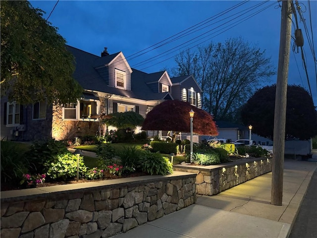 62 Andrews Ave, West Warwick, RI 02893 - view of front of home with a chimney and stone siding
