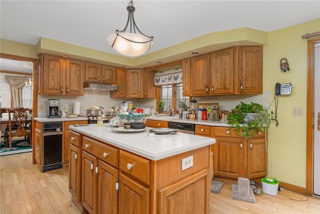 6 Lake Dr, North Providence, RI 02904 - kitchen featuring stainless steel dishwasher, light wood finished floors, under cabinet range hood, and light countertops