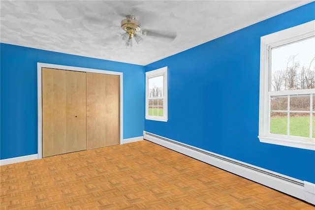 6 Lake Dr, North Providence, RI 02904 - unfurnished bedroom with baseboard heating, a closet, baseboards, and a ceiling fan