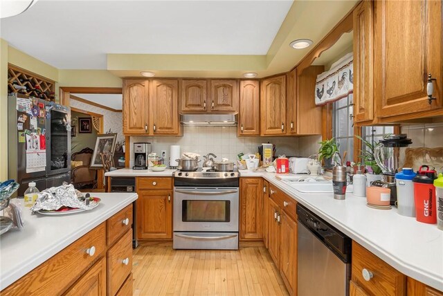 6 Lake Dr, North Providence, RI 02904 - kitchen with appliances with stainless steel finishes, under cabinet range hood, light countertops, brown cabinets, and recessed lighting