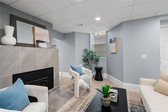 22 Halsey St Unit 1, Providence, RI 02906 - living area with wood finished floors, baseboards, a tiled fireplace, a drop ceiling, and recessed lighting