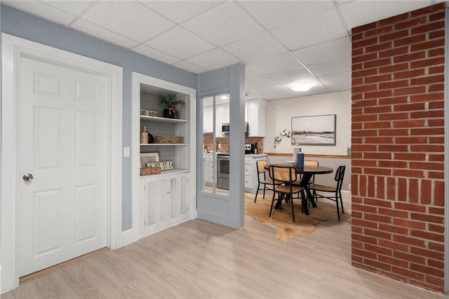 22 Halsey St Unit 1, Providence, RI 02906 - dining area featuring a paneled ceiling, light wood-style flooring, and baseboards