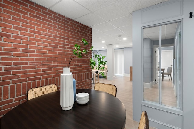 22 Halsey St Unit 1, Providence, RI 02906 - dining space with brick wall, a paneled ceiling, wood finished floors, baseboards, and recessed lighting