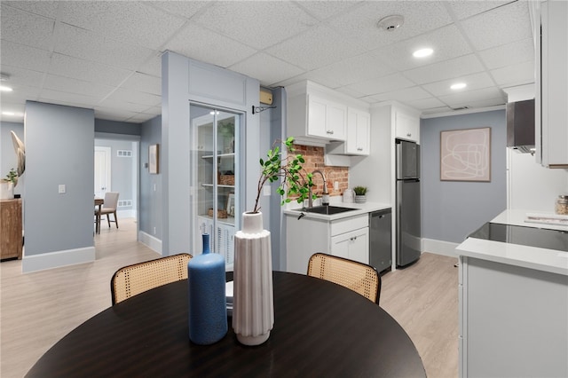 22 Halsey St Unit 1, Providence, RI 02906 - dining area featuring a paneled ceiling, light wood-type flooring, and baseboards