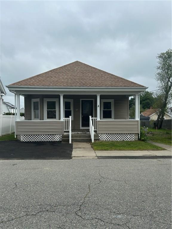 26 Mayflower St, East Providence, RI 02914 - bungalow-style home featuring a shingled roof and covered porch
