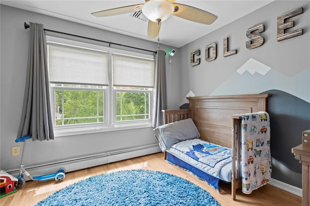 5 Olivia Ct, Johnston, RI 02919 - bedroom with baseboard heating, wood finished floors, and a ceiling fan