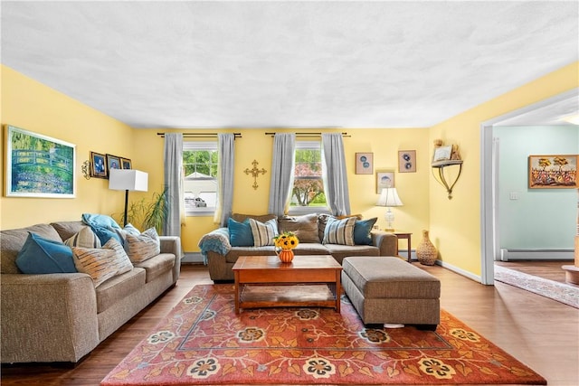 67 Hathaway Dr, West Warwick, RI 02893 - living room featuring wood finished floors and a baseboard heating unit