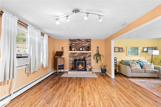 67 Hathaway Dr, West Warwick, RI 02893 - living room with a baseboard heating unit, wood finished floors, cooling unit, and baseboards