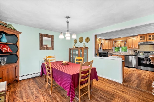67 Hathaway Dr, West Warwick, RI 02893 - dining room with a baseboard heating unit, wood finished floors, and a chandelier