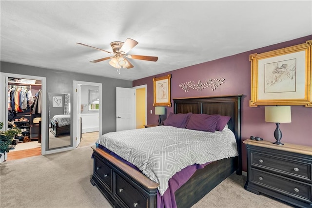67 Hathaway Dr, West Warwick, RI 02893 - bedroom with a walk in closet, light colored carpet, a closet, ceiling fan, and ensuite bathroom