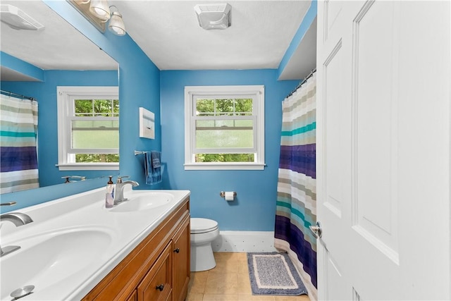 67 Hathaway Dr, West Warwick, RI 02893 - bathroom featuring toilet, double vanity, baseboards, tile patterned flooring, and a shower with curtain