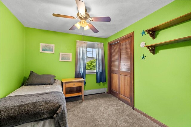 67 Hathaway Dr, West Warwick, RI 02893 - bedroom featuring carpet flooring, a baseboard radiator, baseboards, a closet, and ceiling fan