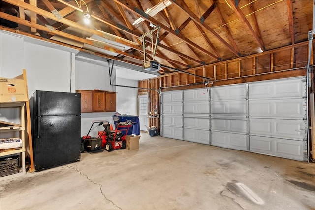 67 Hathaway Dr, West Warwick, RI 02893 - garage featuring freestanding refrigerator and a garage door opener