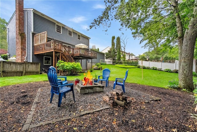 67 Hathaway Dr, West Warwick, RI 02893 - back of house with an outdoor fire pit, a wooden deck, and a chimney