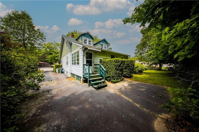 102 Buttonwoods Ave, Warwick, RI 02886 - view of front of property featuring driveway and a chimney