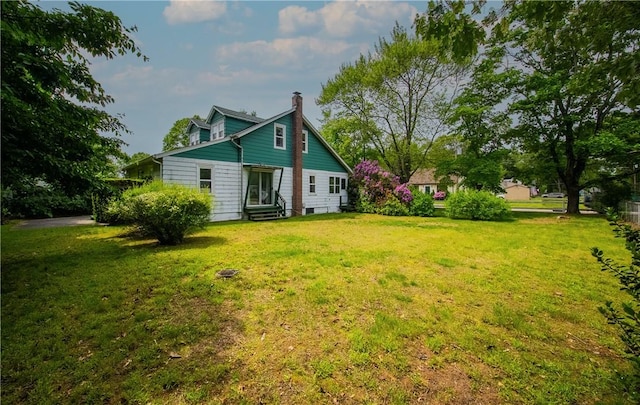 102 Buttonwoods Ave, Warwick, RI 02886 - rear view of property with a chimney, a lawn, and entry steps
