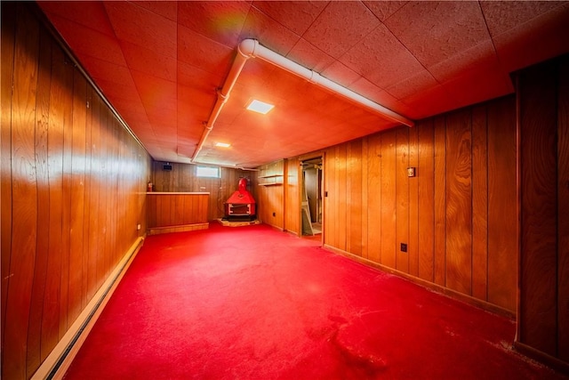 102 Buttonwoods Ave, Warwick, RI 02886 - bonus room featuring a wood stove, baseboard heating, carpet floors, and wood walls