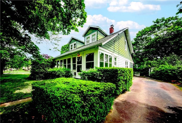 102 Buttonwoods Ave, Warwick, RI 02886 - view of side of home with a chimney and driveway