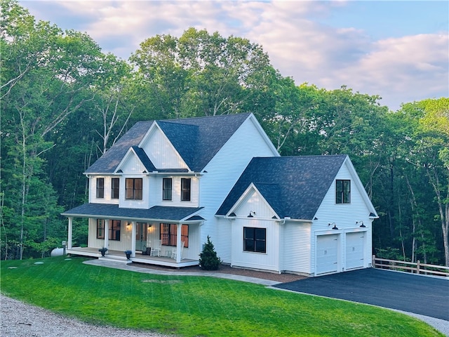 757 Cooper Rd, Glocester, RI 02814 - view of front facade with covered porch, board and batten siding, driveway, a shingled roof, and an attached garage