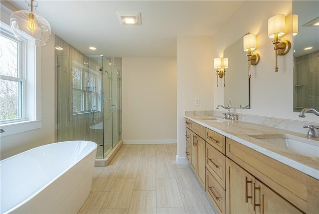 757 Cooper Rd, Glocester, RI 02814 - full bath with a freestanding tub, a shower stall, double vanity, baseboards, and recessed lighting