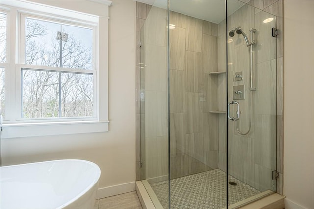 757 Cooper Rd, Glocester, RI 02814 - bathroom featuring baseboards, a freestanding tub, a stall shower, and healthy amount of natural light