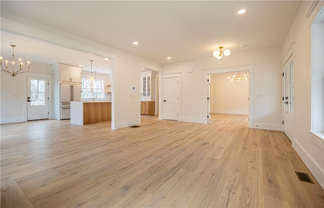 757 Cooper Rd, Glocester, RI 02814 - unfurnished living room with a chandelier, light wood-style floors, recessed lighting, baseboards, and a sink